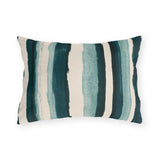 Teal and cream painted stripes on an outdoor lumbar pillow
