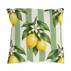 Watercolor lemons with leaves and white blossoms on a sage green and cream striped outdoor pillow