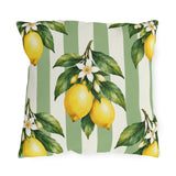 Watercolor lemons with leaves and white blossoms on a sage green and cream striped outdoor pillow