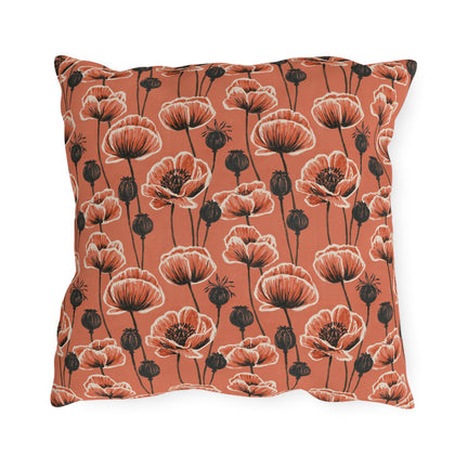 Coral poppies and black seed heads on terracotta outdoor pillow