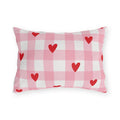 Light pink gingham outdoor lumbar pillow with small red hearts