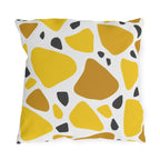 Yellow terrazzo outdoor pillow with large yellow and ochre stones and charcoal chips on white
