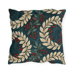 Cream laurel branches and red berries on a deep teal outdoor pillow