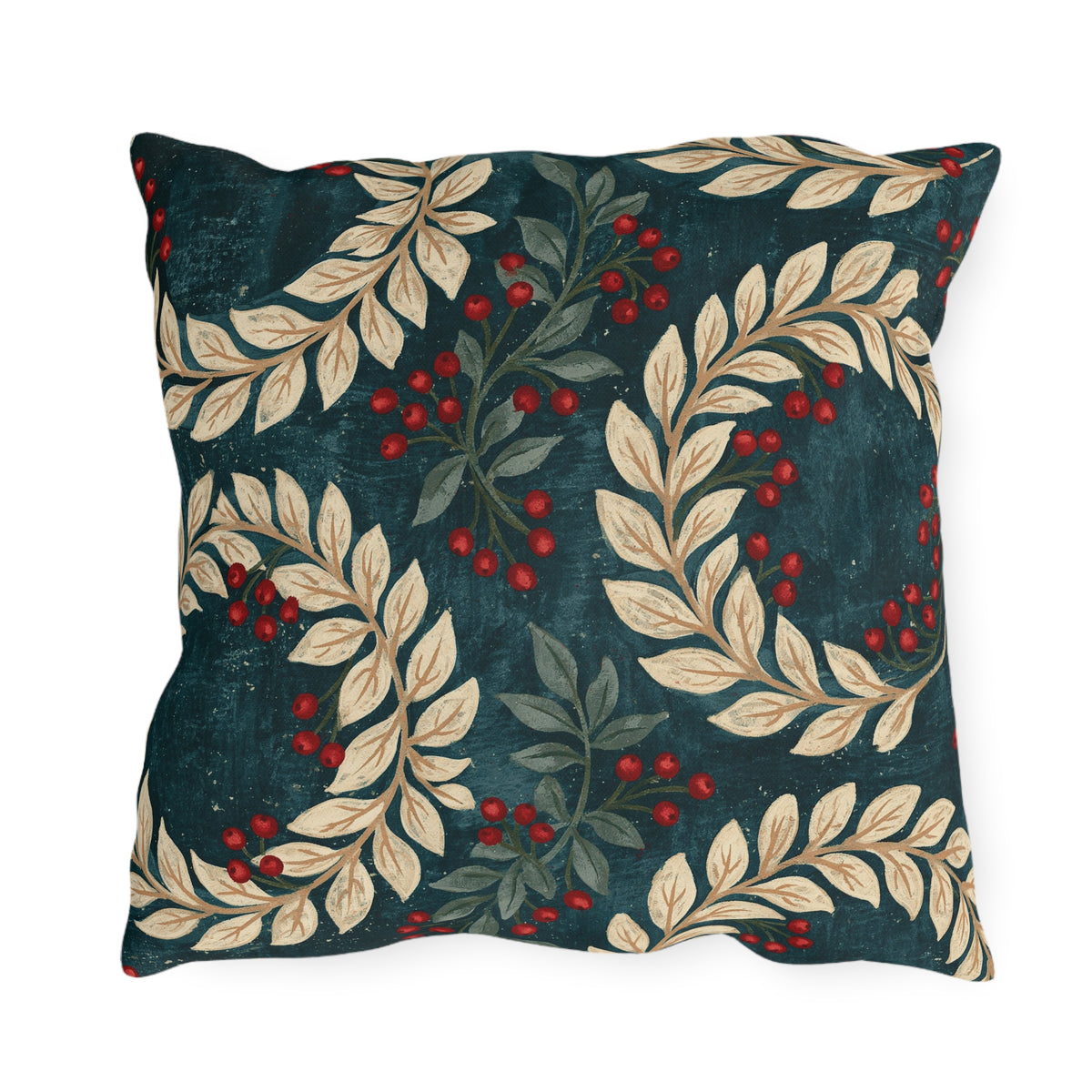 Cream laurel branches and red berries on a deep teal outdoor pillow
