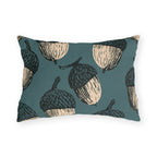 Oversized cream and black block print acorns on a deep teal outdoor lumbar pillow