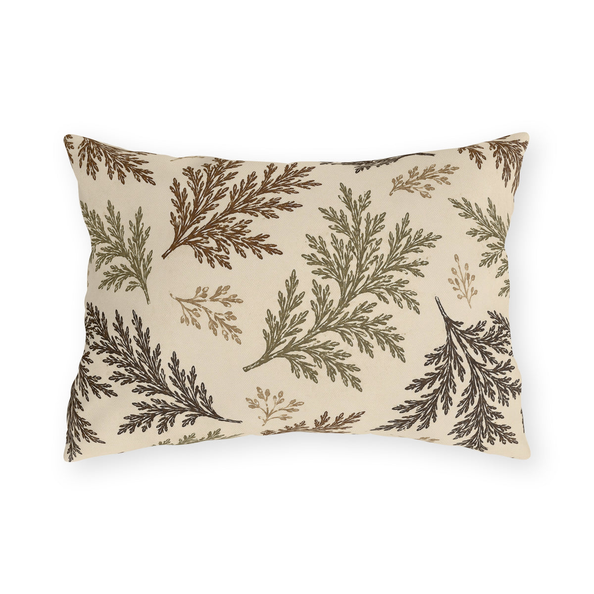 Cedar sprigs in brown, olive and tan scattered on a cream outdoor lumbar pillow
