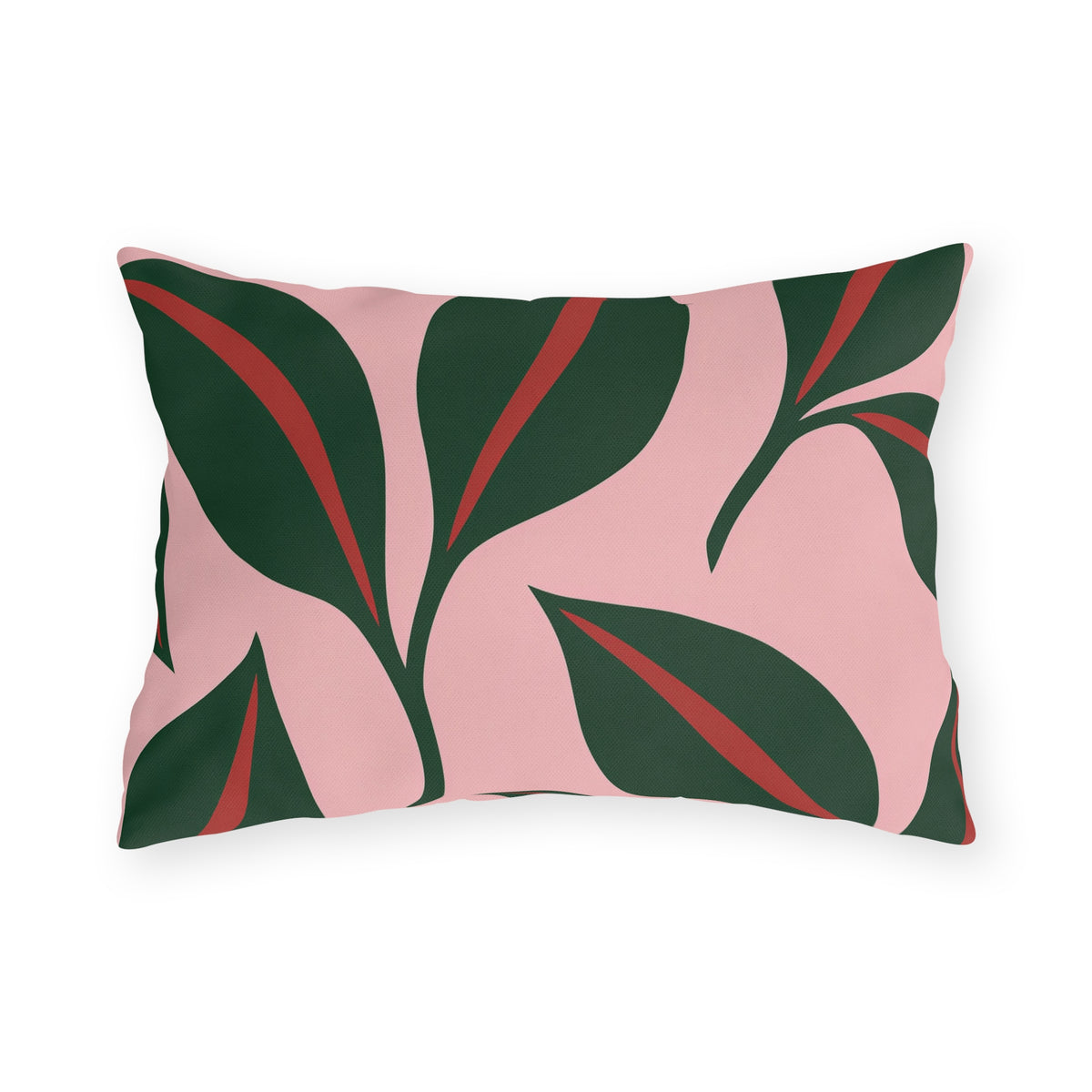 Modern outdoor lumbar pillow with oversized forest green leaves and red midribs on blush pink