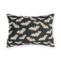 Bone white bats on a charcoal outdoor lumbar pillow, worn block print Halloween pattern