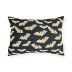 Bone white bats on a charcoal outdoor lumbar pillow, worn block print Halloween pattern