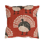 Black and cream block print turkeys on a brick red outdoor pillow