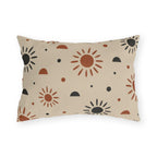 Boho outdoor lumbar pillow with rust and charcoal hand-drawn suns and half circles on light sand