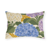 Hydrangea outdoor lumbar pillow with periwinkle blue, lilac and cream hydrangea blooms and sage green leaves