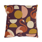 Mid-century flamingo outdoor pillow with coral flamingos and mustard circles on plum