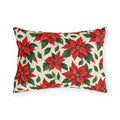 Christmas poinsettia outdoor lumbar pillow with red poinsettia blooms, golden centers and green leaves on warm cream