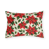 Christmas poinsettia outdoor lumbar pillow with red poinsettia blooms, golden centers and green leaves on warm cream
