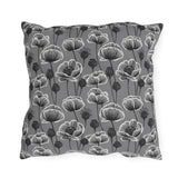 White and charcoal poppies and seed heads on grey outdoor pillow