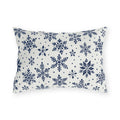 Snowflake outdoor lumbar pillow with navy blue snowflakes and small dots on crisp off-white