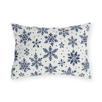 Snowflake outdoor lumbar pillow with navy blue snowflakes and small dots on crisp off-white