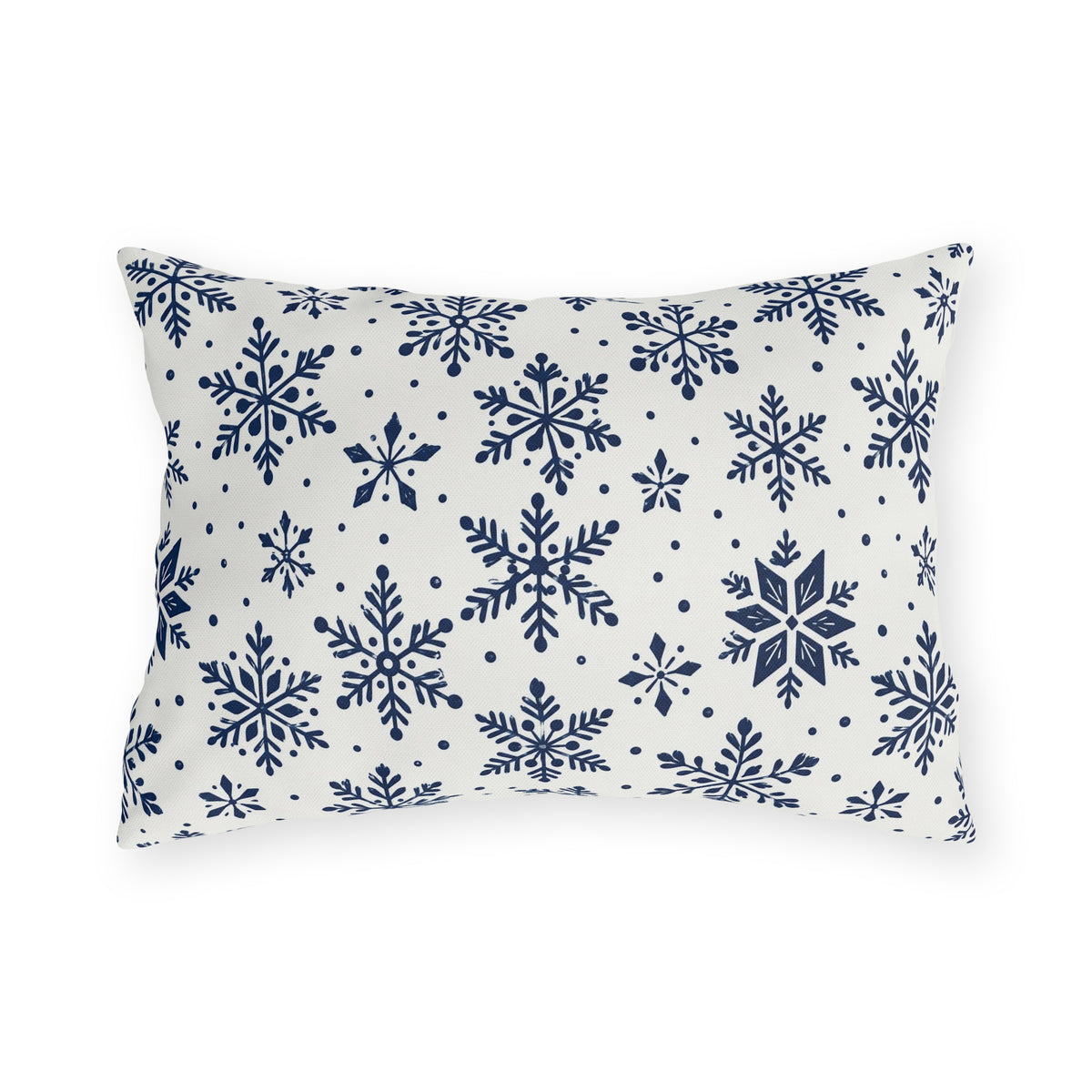 Snowflake outdoor lumbar pillow with navy blue snowflakes and small dots on crisp off-white