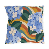 Groovy hydrangea outdoor pillow with cornflower blue hydrangeas over retro orange, mustard and teal waves