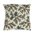 Ivory and sage ribbon bows on cedar sprigs with white berries on a cream outdoor pillow