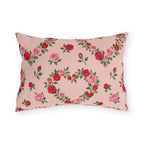 Blush pink outdoor lumbar pillow with heart-shaped wreaths of pink and red roses