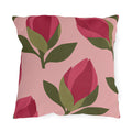 Floral outdoor pillow with cut-paper raspberry pink flower buds and olive green leaves on blush
