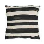 Wide black brushed stripes on a cream outdoor pillow