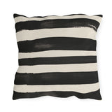 Wide black brushed stripes on a cream outdoor pillow