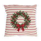 Christmas wreath outdoor pillow with a pine and berry wreath and red bow on cream with cranberry pinstripes