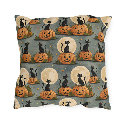 Black cats sitting on carved pumpkins under full moons on sage grey outdoor pillow