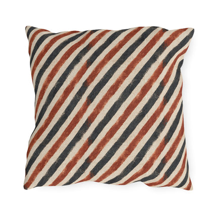 Diagonal rust and charcoal block-printed stripes on cream outdoor pillow