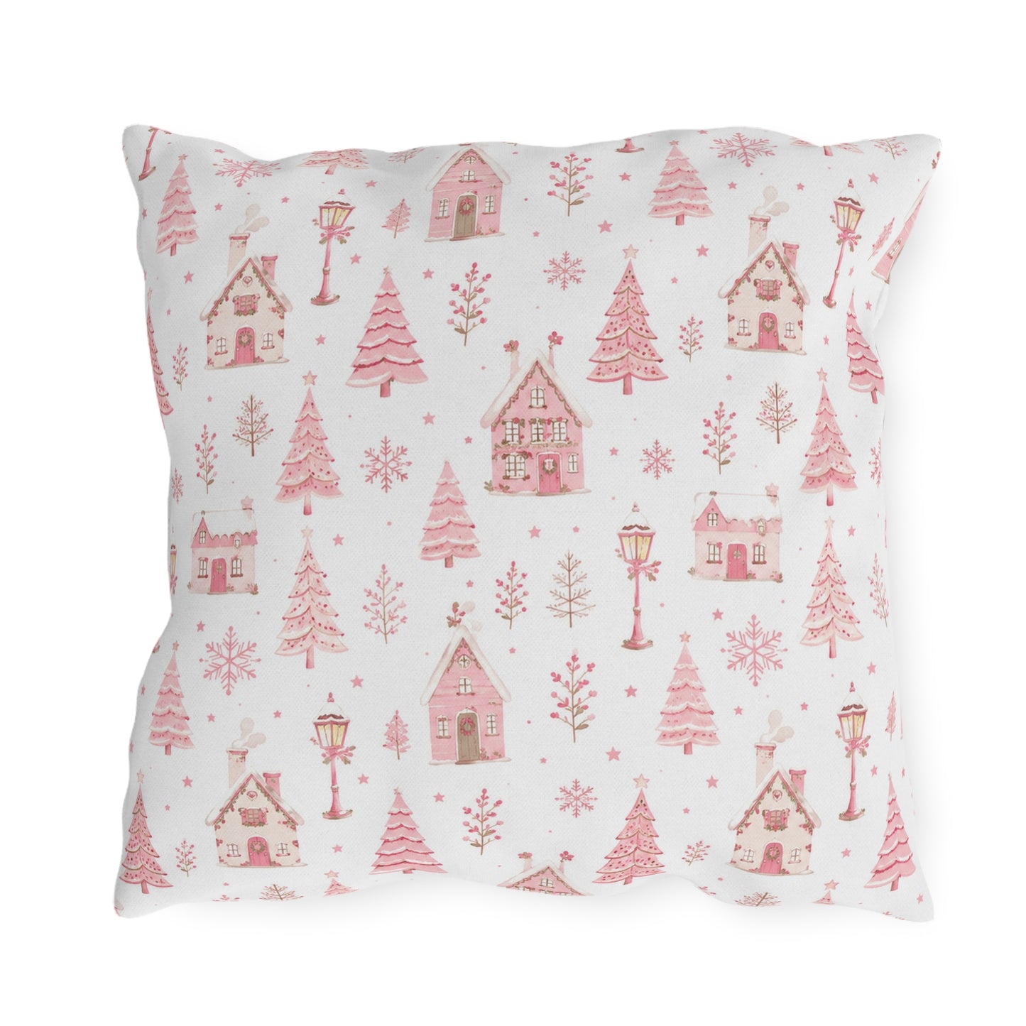 Pink gingerbread houses, trees and lampposts on white outdoor pillow