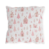 Pink gingerbread houses, trees and lampposts on white outdoor pillow
