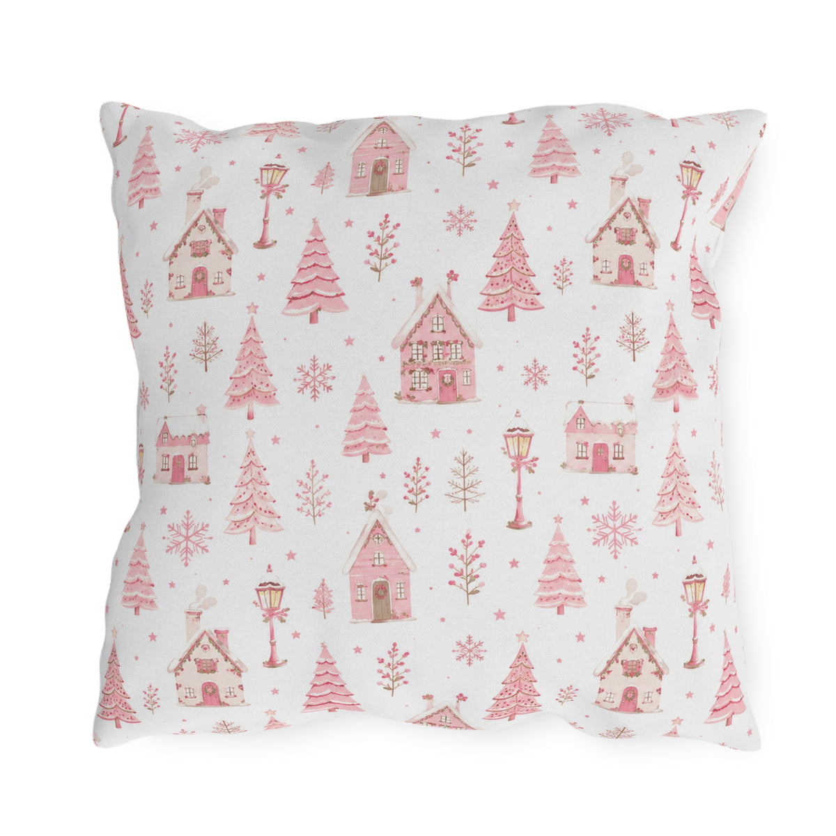 Pink gingerbread houses, trees and lampposts on white outdoor pillow