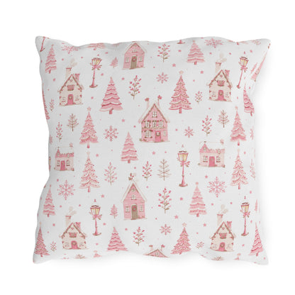 Pink gingerbread houses, trees and lampposts on white outdoor pillow