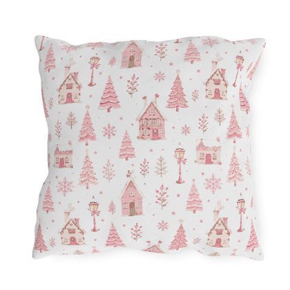 Pink gingerbread houses, trees and lampposts on white outdoor pillow