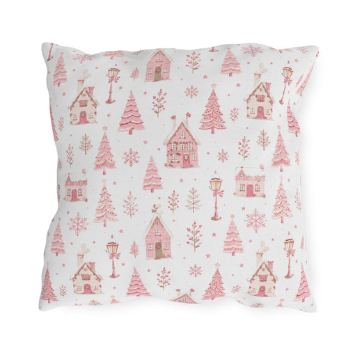 Pink gingerbread houses, trees and lampposts on white outdoor pillow