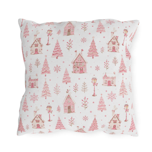 Pink gingerbread houses, trees and lampposts on white outdoor pillow