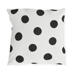 Black and white polka dot outdoor pillow with large hand-painted charcoal dots on warm white
