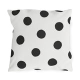Black and white polka dot outdoor pillow with large hand-painted charcoal dots on warm white