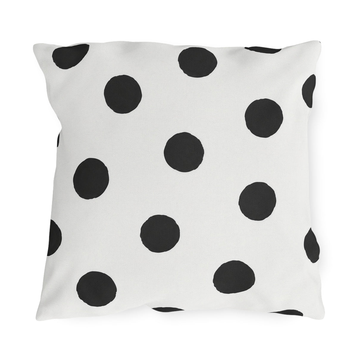 Black and white polka dot outdoor pillow with large hand-painted charcoal dots on warm white