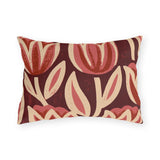 Oversized block print tulips in rose and cream on a deep oxblood outdoor lumbar pillow