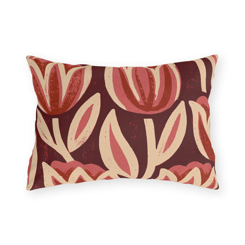 Oversized block print tulips in rose and cream on a deep oxblood outdoor lumbar pillow