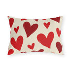 Valentine's outdoor lumbar pillow with hand-painted red hearts tossed across cream