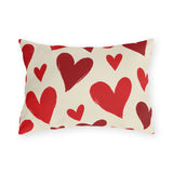 Valentine's outdoor lumbar pillow with hand-painted red hearts tossed across cream