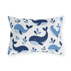Coastal outdoor lumbar pillow with tossed navy and sky blue whales with water spouts on white