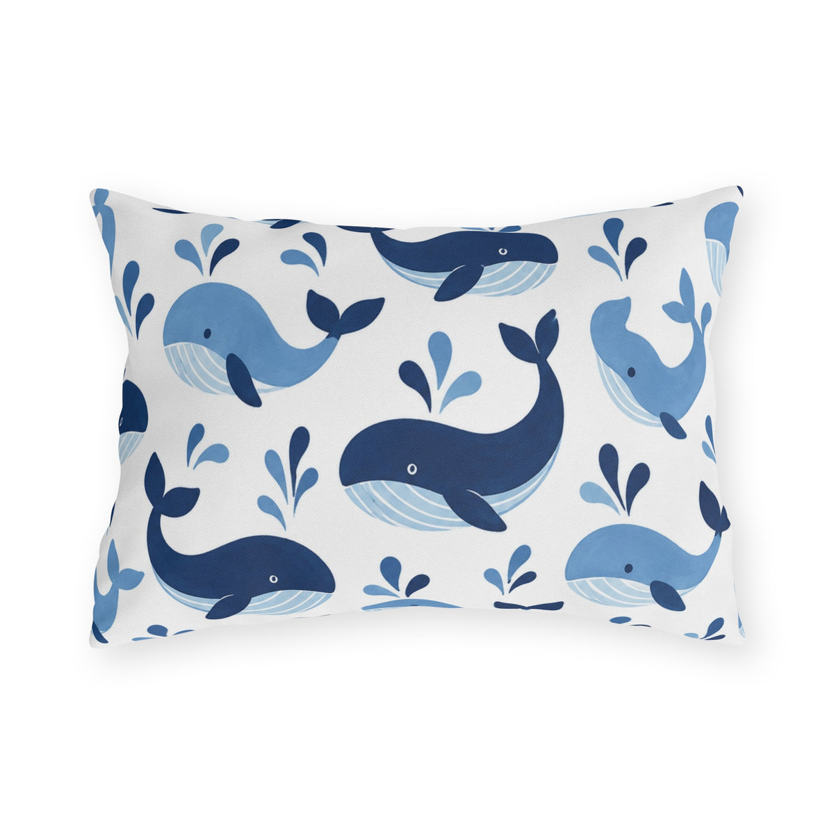 Coastal outdoor lumbar pillow with tossed navy and sky blue whales with water spouts on white