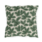 Deep green pine and fir branches on cream outdoor pillow
