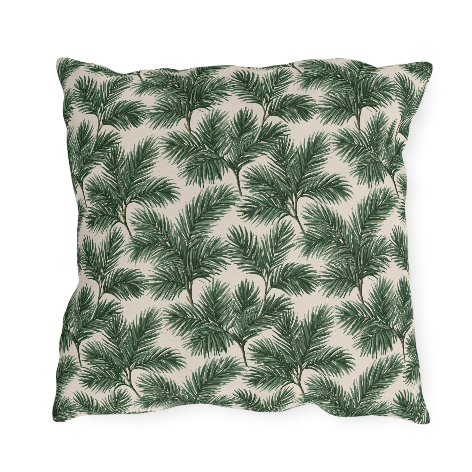 Deep green pine and fir branches on cream outdoor pillow